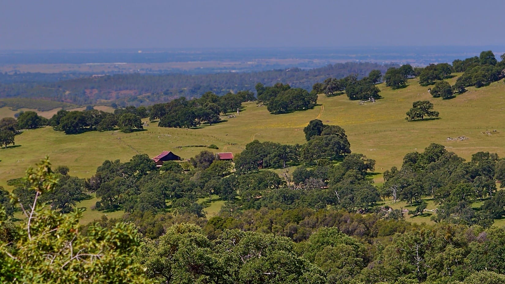 Rolling oak-covered hills of El Dorado Ranch stretching to a distant valley horizon.